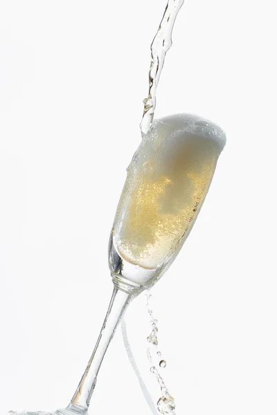 White wine splashing out of glass, isolated on white background — Stock Photo, Image