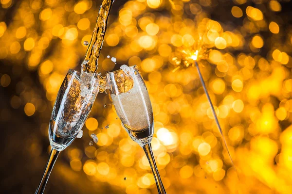 New Year's at midnight with champagne glasses on light background — Stock Photo, Image