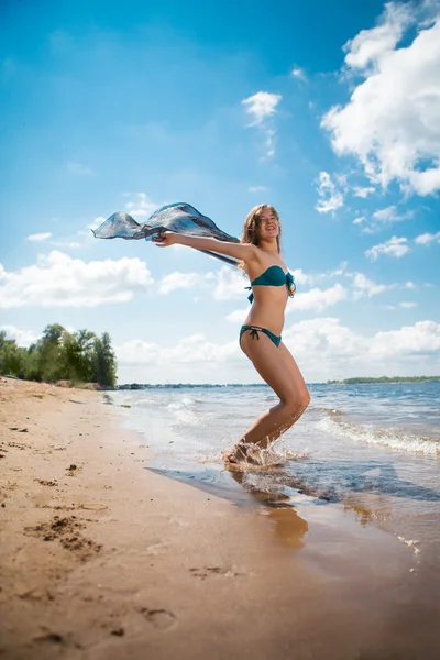 Pretty slim woman with black pareo posing on the beach — Stock Photo, Image