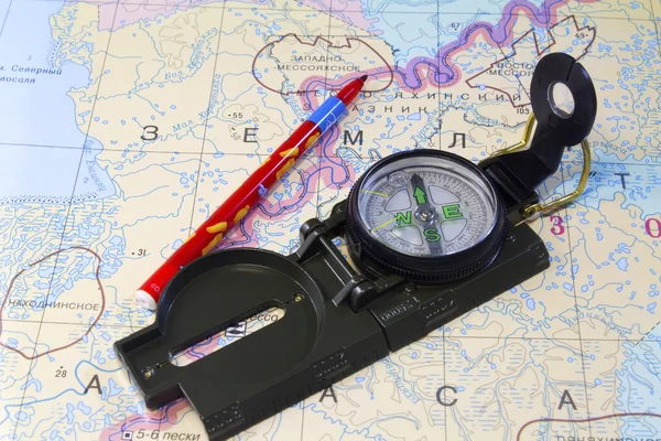 Compass, pencil and a fragment of the map of the North of Russia — Stock Photo, Image