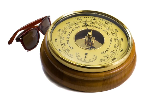 Barometer - aneroid on a white background and black sunglasses — Stok fotoğraf