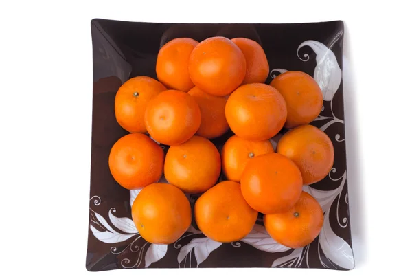 Large ripe tangerines in a glass dish on a white background. — Stock Photo, Image