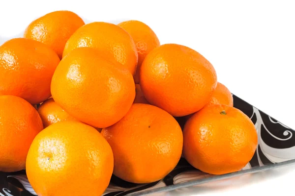 Large ripe tangerines in a glass dish on a white background. — Stock Photo, Image