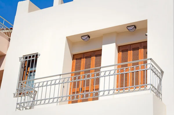 Fragment of a facade of a house with a balcony and blinds from t — Stock Photo, Image