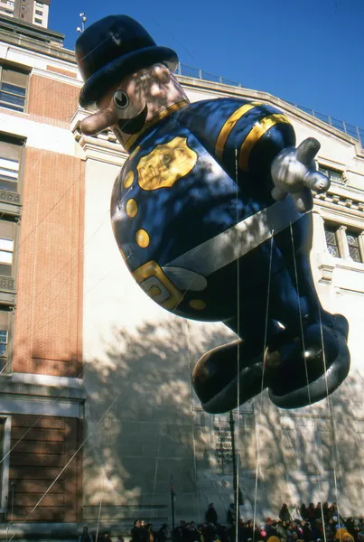 NEW YORK-NOV 22: A holiday tradition since 1924, the annual Macy's Thanksgiving Day Parade is seen by more than 3.5 million people. Pictured here in 2012 is the Harold the Policeman balloon. — Stock Image NEW YORK-NOV 22: A holiday tradition since 1924, the annual Macy's Thanksgiving Day Parade is seen by more than 3.5 million people. Pictured here in 2012 is the Harold the Policeman balloon. Stock Photo