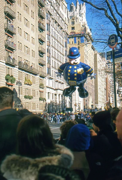 NEW YORK-NOV 22: A holiday tradition since 1924, the annual Macy's Thanksgiving Day Parade is seen by more than 3.5 million people. Pictured here in 2012 is the Harold the Policeman balloon. — Stock Image NEW YORK-NOV 22: A holiday tradition since 1924, the annual Macy's Thanksgiving Day Parade is seen by more than 3.5 million people. Pictured here in 2012 is the Harold the Policeman balloon. Royalty Free Stock Images