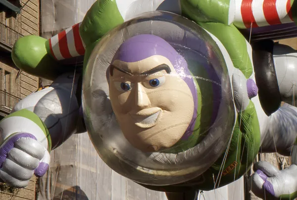 NEW YORK-NOV 24: A holiday tradition since 1924, the annual Macy's Thanksgiving Day Parade is seen by more than 3.5 million people. Pictured here in 2011 is Disney's Buzz Lightyear. — Stock Image NEW YORK-NOV 24: A holiday tradition since 1924, the annual Macy's Thanksgiving Day Parade is seen by more than 3.5 million people. Pictured here in 2011 is Disney's Buzz Lightyear. Stock Photo
