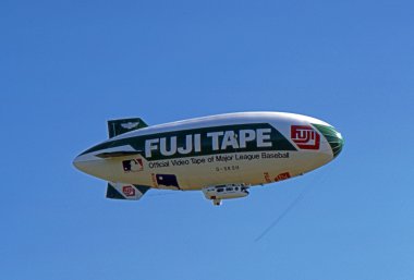 SOLBERG AIRPORT-READINGTON, NEW JERSEY, USA-JULY 17: The Fuji Blimp, advertising symbol of the Fuji Corporation, is seen flying over the 1987 New Jersey Festival of Hot Air Ballooning. clipart