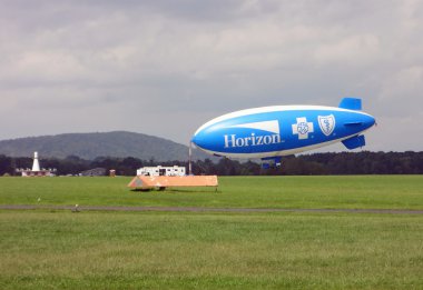 SOLBERG AIRPORT-READINGTON, NEW JERSEY, USA-SEPT 06: Seen attached to the mooring mast in 2012 is the Horizon Blue Cross Blue Shield blimp. clipart