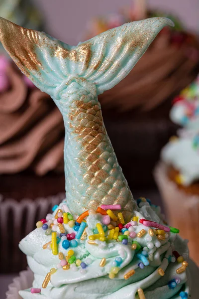在巧克力松饼上手工制作的绿色美人鱼尾巴为生日派对烘焙甜点手饼 — 图库照片