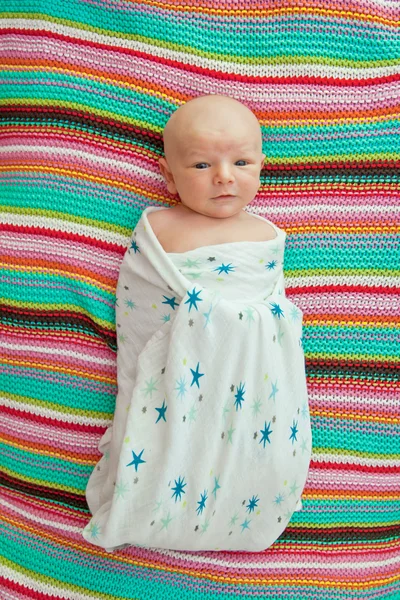 Little smiley baby swaddle with bamboo blankets — Stock Photo, Image