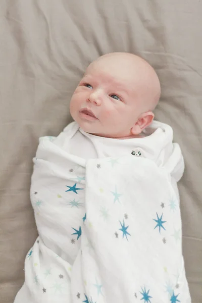 Little smiley baby swaddle with bamboo blankets — Stock Photo, Image