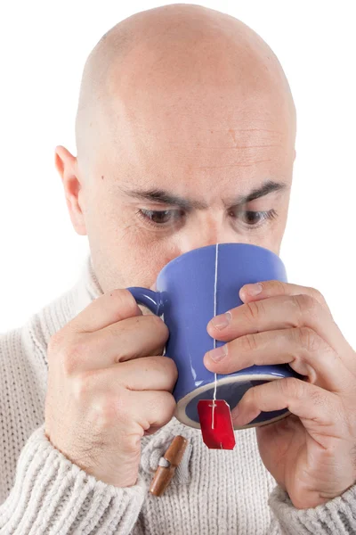 Man drinking a hot drink in a mug. — Stock Photo, Image