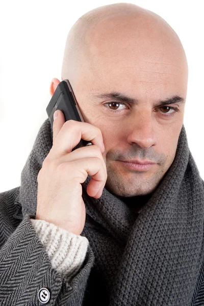 Man with coat and scarf on the phone. — Stock Photo, Image