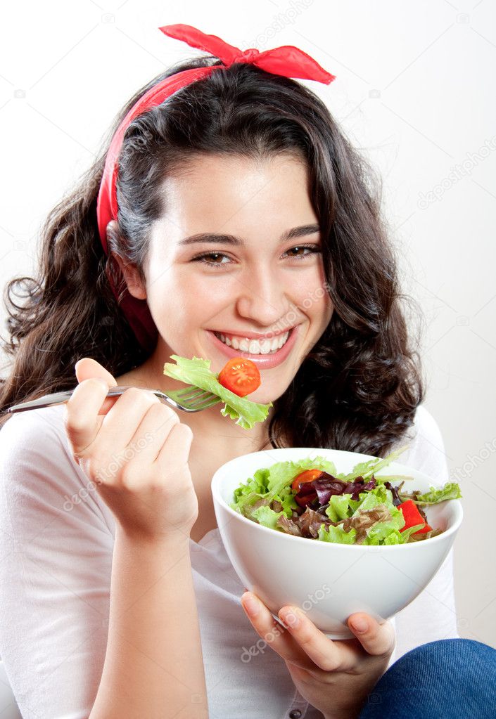 Happy girl eating salad