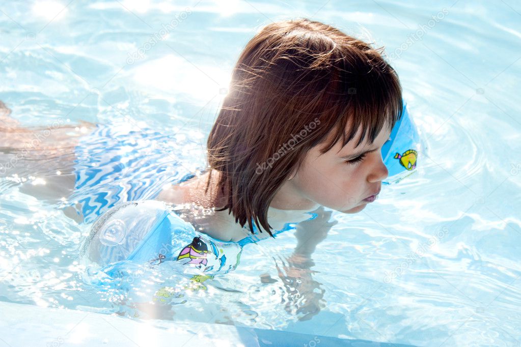 Little girl swimming in a pool