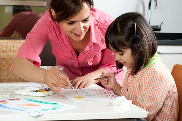 Mother and daughter painting together Royalty Free Stock Images