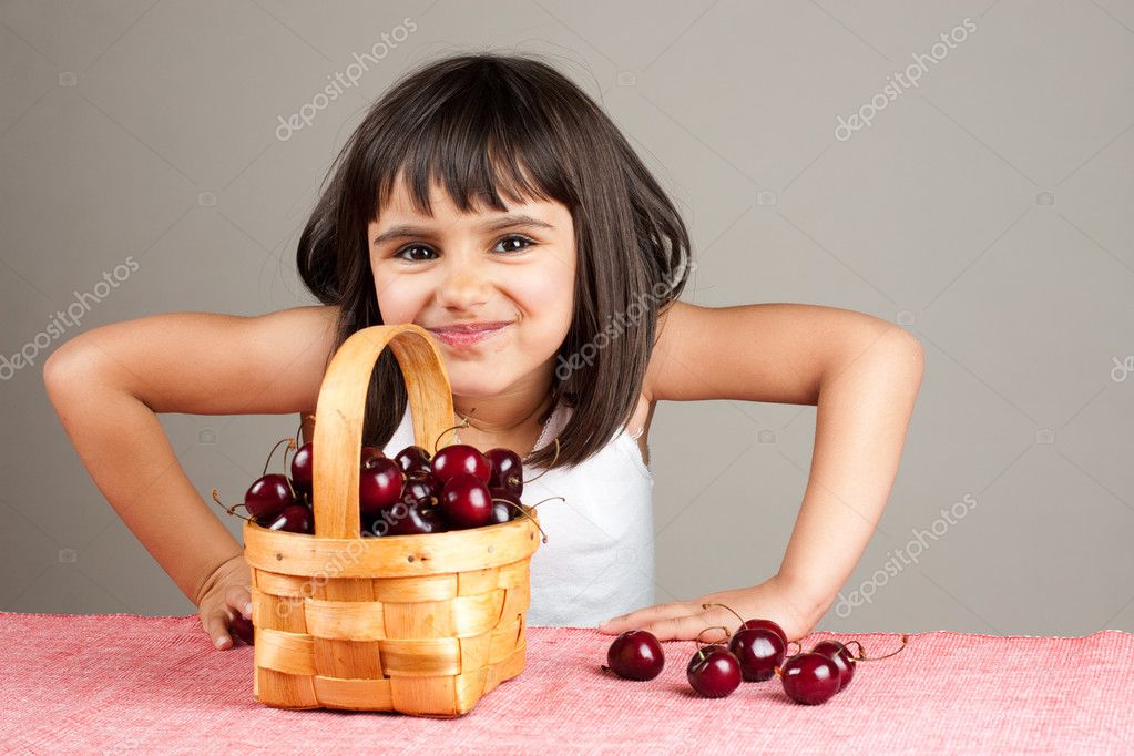 Happy little girl eating cherries — Stock Photo © asife 27696459