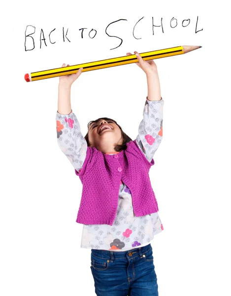 Laughing little girl holding a big pencil — Stock Photo, Image