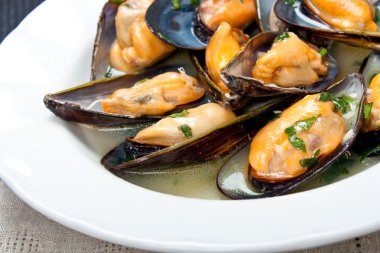 Mussels with white wine and parsley sauce clipart