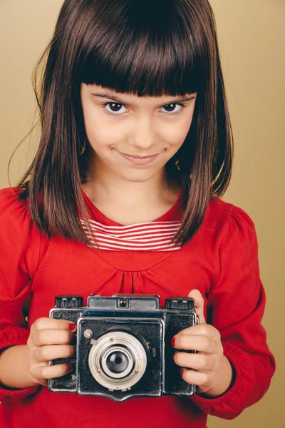 Little retro photographer with an old camera — Stock Photo, Image