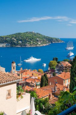 The famous Wellcome Hotel on the Cote d'Azur. Promenade Villefranche-sur-Mer, a resort on the French Riviera. Sea, yachts and boats in the sunlight.
