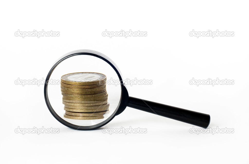 Coins with a magnifying glass