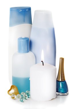 farklı kozmetik ve yanan bir mum ile şişe