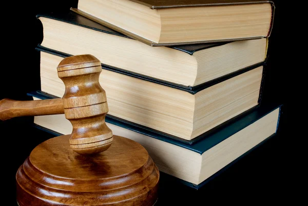Wood gavel, soundblock and stack of thick old books — Stock Photo, Image