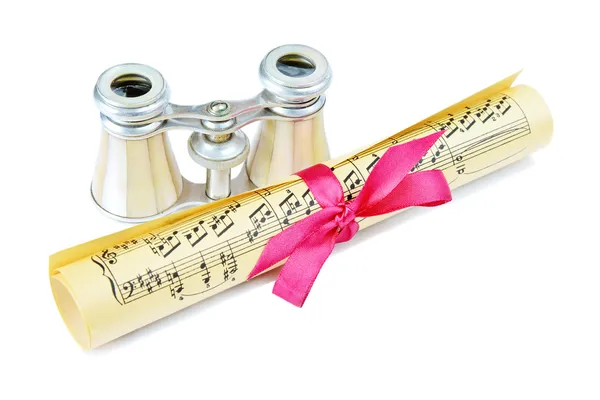 Opera glasses and roll with musical notes — Stock Photo, Image