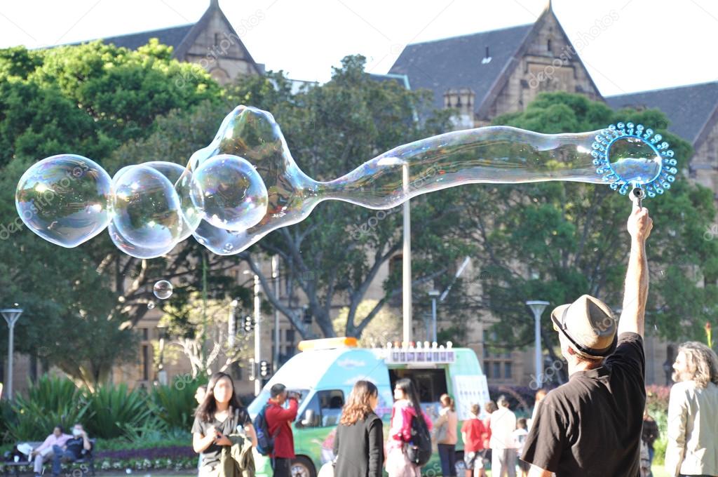 A man playing big bubbles