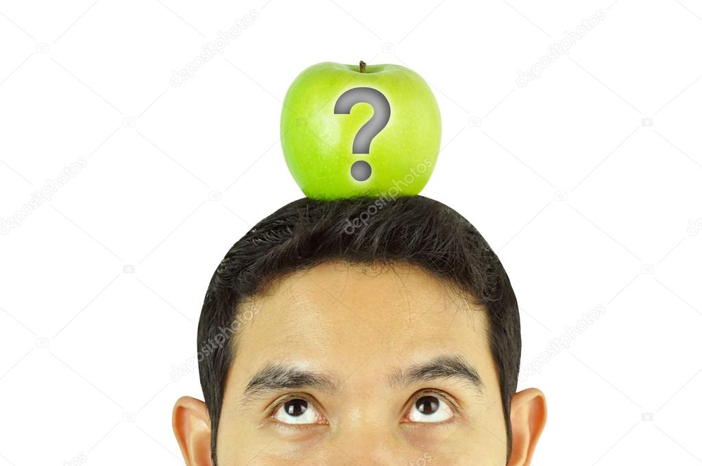 A man looking up to green apple