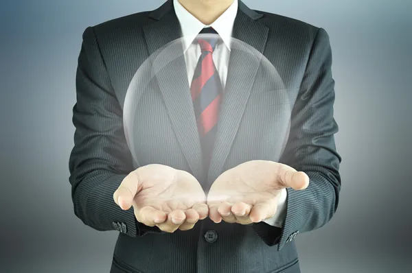 Businessman holding empty transparent ball — Stock Photo, Image