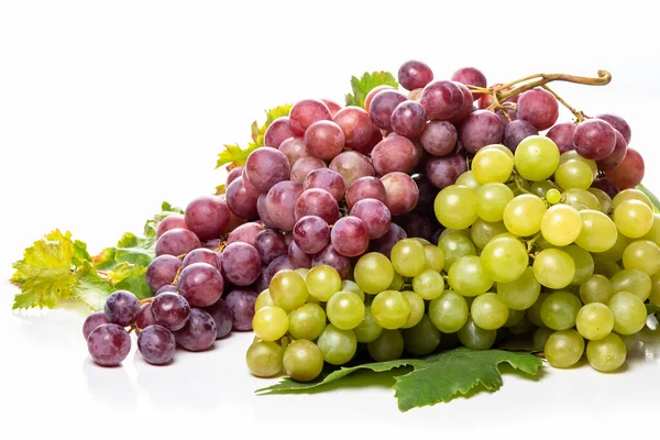 Clusters of white and pink grapes and grape leaves on a white background. isolate