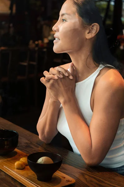 Smiling beautiful asian woman at the restaurant. High quality photo