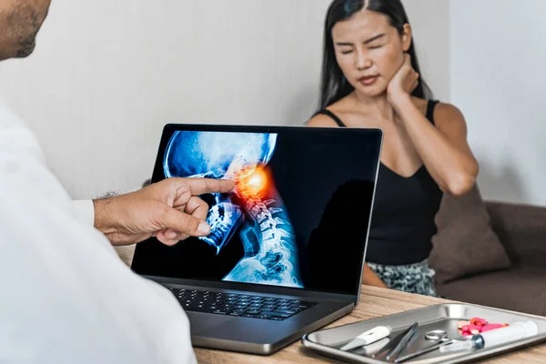 Doctor showing a x-ray of pain in the brain. Woman patient holding her head. Migraine Headache concept. High quality photo