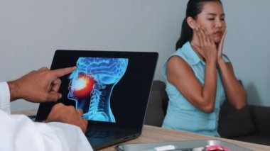 Dentist showing x-ray of mouth on a laptop with woman patient. High quality 4k footage