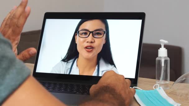 Doctor Having Distant Online Conversation Man Patient Thumb Sanitizer Mask — Stockvideo