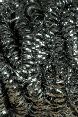 steel tangled spiral metal fibers background, macro photography close-up
