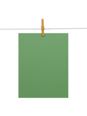 Green paper sheet on a clothes line (with 2 clipping paths) clipart