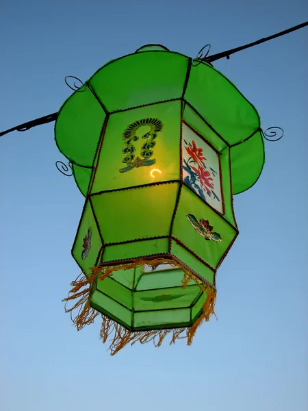 Cozy light of a green Chinese lantern