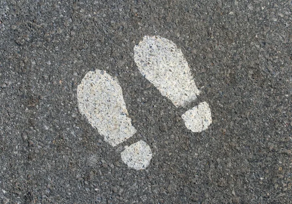 Painted footprints on asphalt — Stock Photo, Image