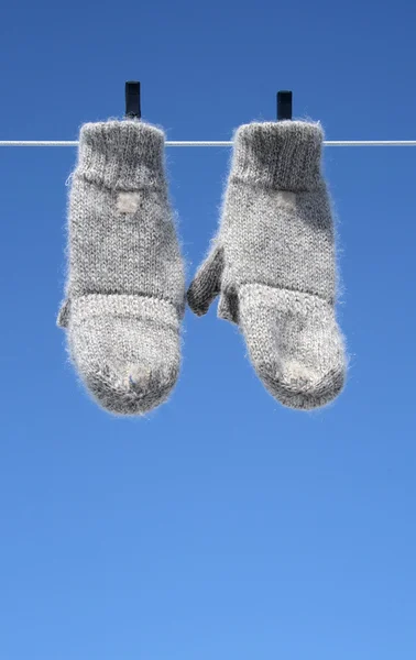 Mittens hanging to dry - the winter is over — Stock Photo, Image