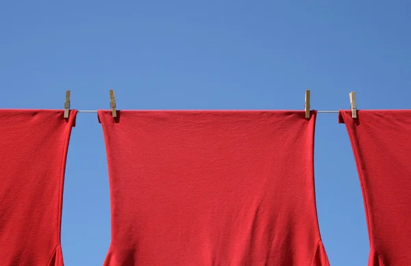 T-shirt rosse su una linea di vestiti — Foto Stock