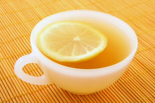 Cup of tea with lemon in warm golden light — Stock Photo, Image