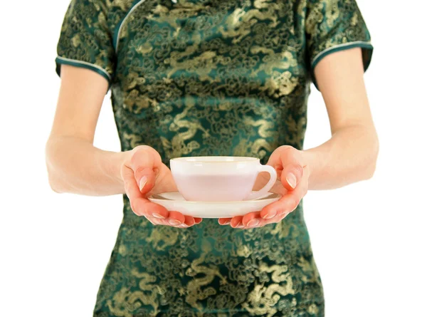 Woman in Chinese dress offering a cup of tea — Stock Photo, Image