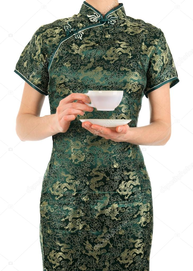 Woman in Chinese dress holding a cup of tea