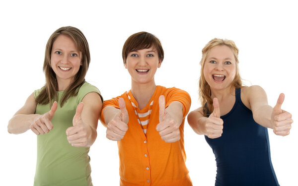 Three happy young women giving thumbs up