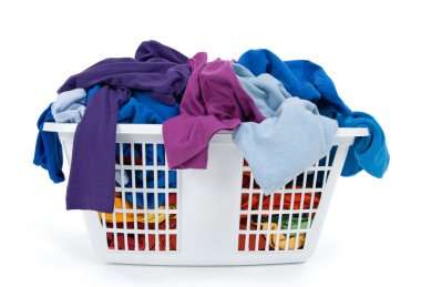 Colorful clothes in laundry basket. Blue, indigo, purple.