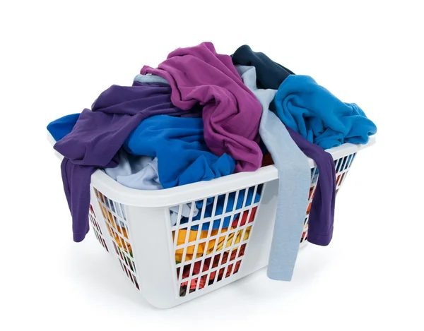 Bright clothes in laundry basket. Blue, indigo, purple. — Stock Photo, Image